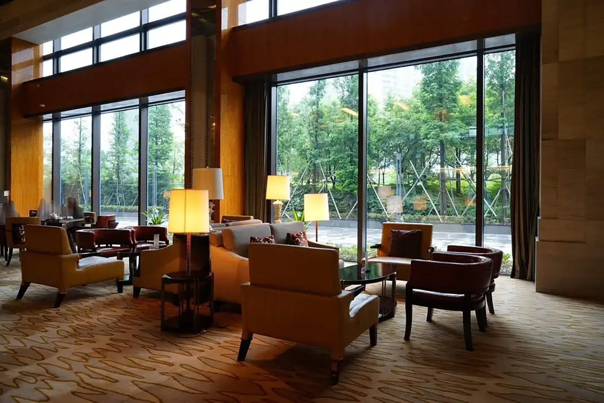 Hotel lobby with floor-to-ceiling glass windows.